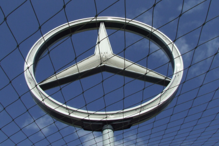 Mercedes Benz logo against a blue sky