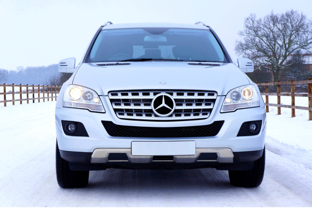 white mercedes benz driving in snow