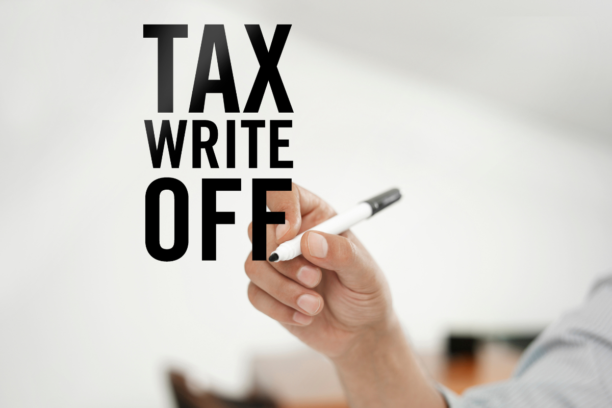 hand writing the words "tax write off"